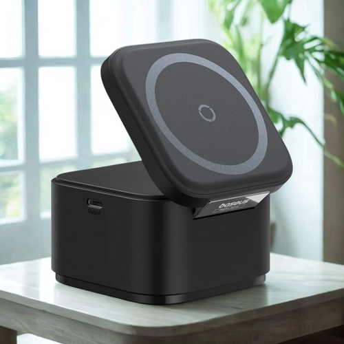 Black wireless charging pad on a wooden surface with a blurred background